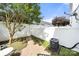 Fenced backyard with green grass, an AC unit, and a small patio with a table and chairs at 12342 Carrigan Ct, Huntersville, NC 28078