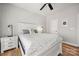 Serene bedroom featuring hardwood floors and a white bed with decorative pillows at 12342 Carrigan Ct, Huntersville, NC 28078