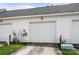 A two-car garage with white doors, a driveway, and a bit of green grass at 12342 Carrigan Ct, Huntersville, NC 28078