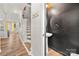 Inviting hallway with hardwood floors and staircase leading to the upper level at 12342 Carrigan Ct, Huntersville, NC 28078