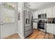 Bright kitchen with stainless steel appliances, white cabinets, and hardwood flooring at 12342 Carrigan Ct, Huntersville, NC 28078