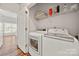 Efficient laundry room with a washer, dryer, and convenient storage shelves at 12342 Carrigan Ct, Huntersville, NC 28078