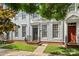 Charming townhome exterior with neat landscaping, dark front door, and sidewalk access at 12342 Carrigan Ct, Huntersville, NC 28078