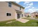 Exterior view of a home with a patio, fenced backyard, and lush green lawn at 124 Glade Valley Ave, Mooresville, NC 28117