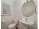 Powder bathroom features modern sink and fixtures, along with updated lighting at 124 Glade Valley Ave, Mooresville, NC 28117