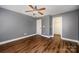 This bedroom features hardwood floors and a ceiling fan and good space at 124 Glade Valley Ave, Mooresville, NC 28117
