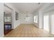 Bright dining room featuring tile floors, natural light, and modern chandelier at 124 Glade Valley Ave, Mooresville, NC 28117
