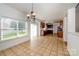 Bright dining room featuring tile floors, natural light, and an open kitchen concept at 124 Glade Valley Ave, Mooresville, NC 28117