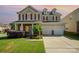 Charming two-story home with a well-manicured lawn, brick accents, and a two-car garage, offering great curb appeal at 124 Glade Valley Ave, Mooresville, NC 28117