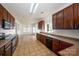 Spacious eat-in kitchen features tile floors, stainless appliances, and granite countertops at 124 Glade Valley Ave, Mooresville, NC 28117