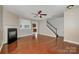 Spacious living room with hardwood floors, fireplace, and an open staircase at 124 Glade Valley Ave, Mooresville, NC 28117