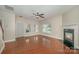 Cozy living room with a fireplace, hardwood floors, and natural light at 124 Glade Valley Ave, Mooresville, NC 28117