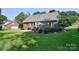 View of the brick home's back exterior, featuring a brick patio and green lawn at 14232 Kendalton Meadow Dr, Mint Hill, NC 28227