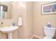 Powder room featuring a pedestal sink, tile flooring, and plenty of decor at 14232 Kendalton Meadow Dr, Mint Hill, NC 28227