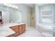 Bathroom featuring a dual vanity, shower, and a separate bathtub at 14232 Kendalton Meadow Dr, Mint Hill, NC 28227