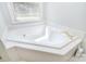 Bright and clean bathtub next to a window at 14232 Kendalton Meadow Dr, Mint Hill, NC 28227