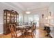 Formal dining room with hardwood floors, a decorative chandelier, and ample natural light at 14232 Kendalton Meadow Dr, Mint Hill, NC 28227