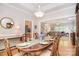 Elegant dining room with hardwood floors, a stylish chandelier, and seamless access to other living areas at 14232 Kendalton Meadow Dr, Mint Hill, NC 28227