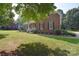 Well-maintained brick home with a welcoming front porch and mature landscaping at 14232 Kendalton Meadow Dr, Mint Hill, NC 28227