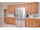 Kitchen featuring stainless steel refrigerator, plenty of cabinet storage, and white countertops at 14232 Kendalton Meadow Dr, Mint Hill, NC 28227