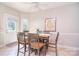 Eat-in kitchen featuring access to backyard, an abundance of sunshine, and tile flooring at 14232 Kendalton Meadow Dr, Mint Hill, NC 28227