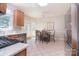 Eat-in kitchen featuring stainless steel appliances, access to the backyard, and plenty of sunshine at 14232 Kendalton Meadow Dr, Mint Hill, NC 28227