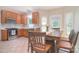 Eat-in kitchen featuring stainless steel appliances, tile floors, wooden cabinets, and access to backyard at 14232 Kendalton Meadow Dr, Mint Hill, NC 28227