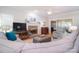 Spacious living room featuring a brick fireplace, hardwood floors, and comfortable seating at 14232 Kendalton Meadow Dr, Mint Hill, NC 28227