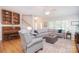 Inviting living room with hardwood floors, a large sectional sofa, and ample natural light at 14232 Kendalton Meadow Dr, Mint Hill, NC 28227