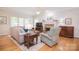 Bright living room with hardwood floors, neutral décor, and a cozy brick fireplace at 14232 Kendalton Meadow Dr, Mint Hill, NC 28227