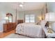 Main bedroom featuring hardwood floors, a four poster bed, plenty of natural light, and furniture at 14232 Kendalton Meadow Dr, Mint Hill, NC 28227