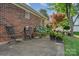 Brick house featuring a landscaped yard with black chairs and flowering shrubs at 1610 Union Rd # 1610B, Gastonia, NC 28054