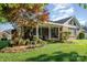 Well-manicured backyard featuring a covered patio, flower beds, and lush lawn at 1610 Union Rd # 1610B, Gastonia, NC 28054