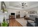 Inviting living room boasts hardwood floors, tray ceiling, fireplace, and open layout to the dining room at 1610 Union Rd # 1610B, Gastonia, NC 28054