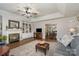 Cozy living room features a fireplace, built-in shelving, hardwood floors, and an open layout to the dining area at 1610 Union Rd # 1610B, Gastonia, NC 28054