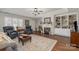 Comfortable living room featuring a fireplace, built-in shelving, hardwood floors, and ample natural light at 1610 Union Rd # 1610B, Gastonia, NC 28054