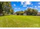 Spacious backyard with a green grass, multiple storage sheds and surrounded by trees at 189 Lochshire Ln, Woodleaf, NC 27054