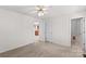 Bright bedroom with ceiling fan with an open door to the kitchen and a bathroom at 189 Lochshire Ln, Woodleaf, NC 27054