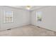Neutral bedroom with ceiling fan and two windows providing plenty of natural light at 189 Lochshire Ln, Woodleaf, NC 27054
