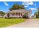Lovely home boasts a cozy front porch and a driveway leading to a detached shed at 189 Lochshire Ln, Woodleaf, NC 27054