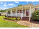 Inviting front porch with white railings and brick steps offers a warm welcome at 189 Lochshire Ln, Woodleaf, NC 27054