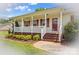 Inviting front porch with classic white columns, brick accents, and a stylish entryway at 189 Lochshire Ln, Woodleaf, NC 27054