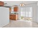 Bright kitchen features light wood cabinetry and a sliding window overlooking the backyard at 189 Lochshire Ln, Woodleaf, NC 27054
