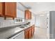 Well-lit kitchen features granite counters, wood cabinets, stainless sink and white appliances at 189 Lochshire Ln, Woodleaf, NC 27054