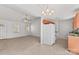 Bright living room open to kitchen featuring neutral color palette, ceiling fan, and ample natural light at 189 Lochshire Ln, Woodleaf, NC 27054