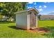 Backyard storage shed with double doors, siding and showing signs of disrepair at 189 Lochshire Ln, Woodleaf, NC 27054