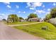 Residential home featuring well-manicured lawn, mature trees, and charming curb appeal at 189 Lochshire Ln, Woodleaf, NC 27054