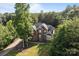Aerial view of brick home and driveway surrounded by lush greenery and mature trees at 2019 Lynmore Dr, Sherrills Ford, NC 28673