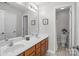 A bright bathroom with double sinks, a large mirror, and a separate toilet area at 2019 Lynmore Dr, Sherrills Ford, NC 28673
