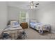 Bright bedroom with twin beds, a window and a ceiling fan at 2019 Lynmore Dr, Sherrills Ford, NC 28673